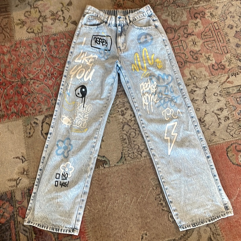 This a pair of hip hop jeans with very cool designs all over the front.